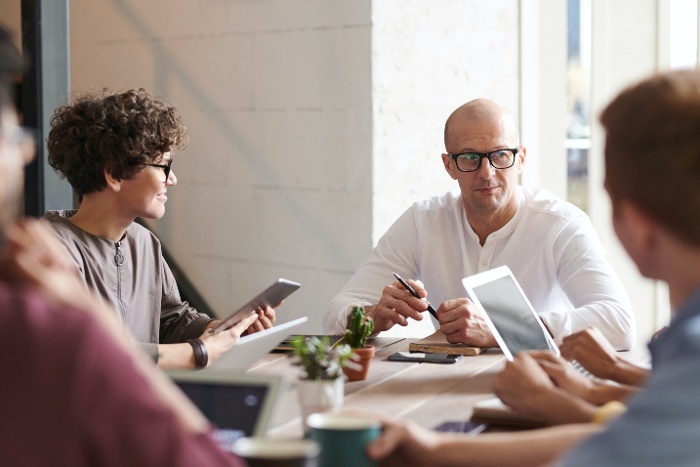 team meeting around table 700x467